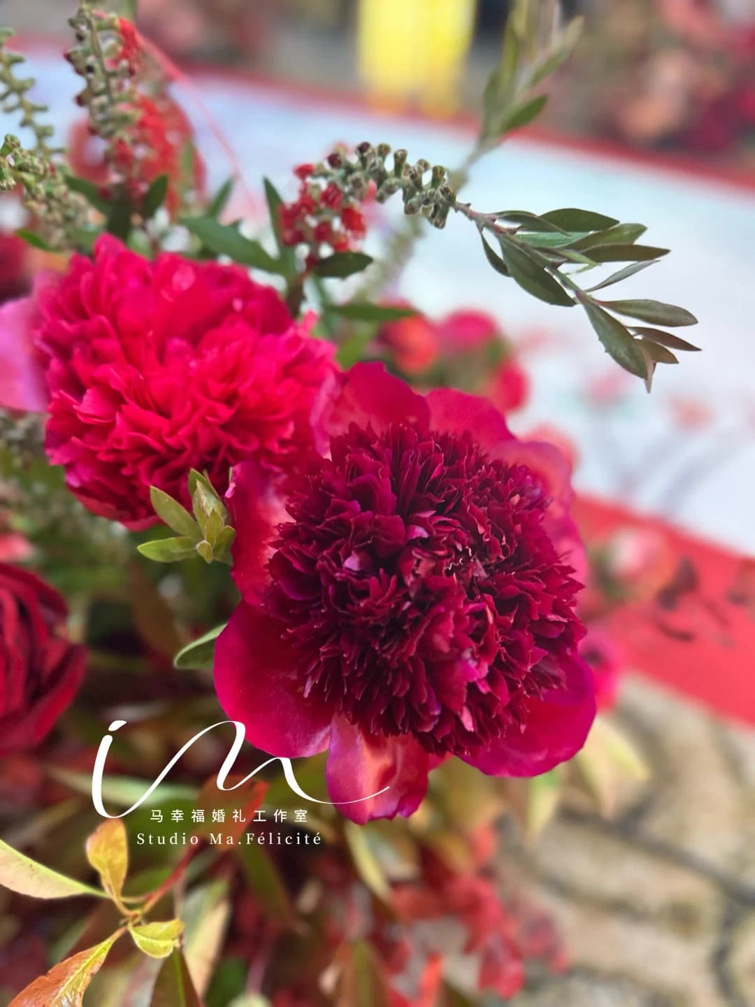 Close-up of deep red peony floral detail from a ceremony arrangement