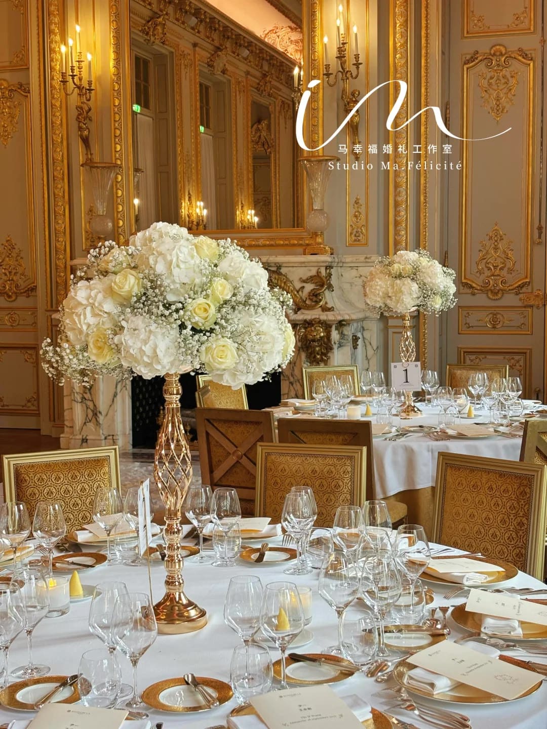 Gold banquet room at the Shangri-La Paris dressed with candlelight and white floral centerpieces